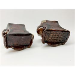 A pair of 19th century treacle glaze pottery sash window rests, H10.5cm. 