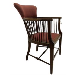 Early 20th century mahogany framed armchair, the raised upholstered back supported by spindles, upholstered seat, square tapering supports joined by swell turned H stretchers and an early to mid 20th century walnut bergère bedroom chair, upholstered seat and back, turned front supports joined by curved stretchers 