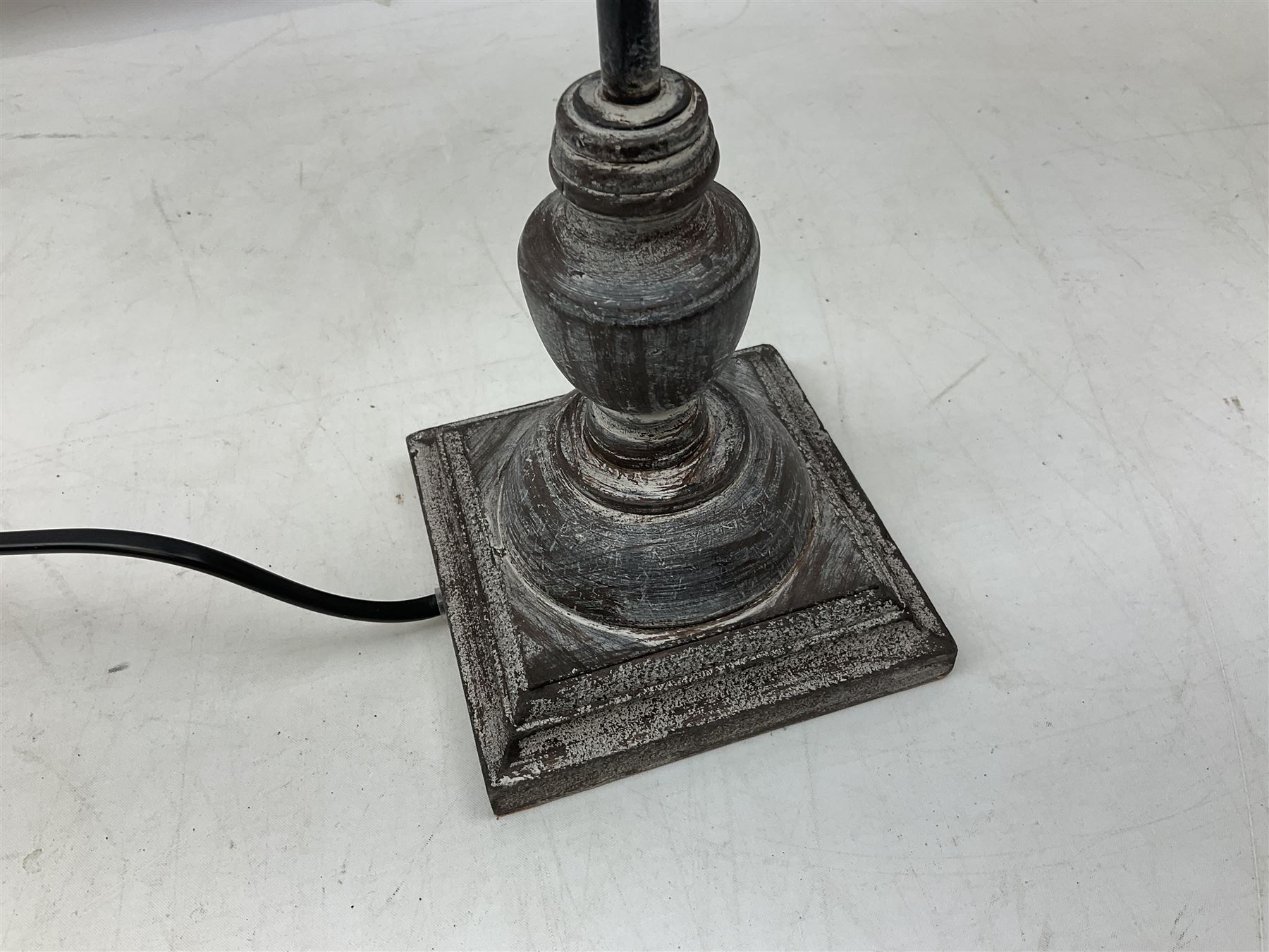 Table lamp, with a thin central stem upon a square stepped base, natural linen shade