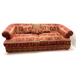 Grande four seat sofa, scrolling arms upholstered in red patterned fabric