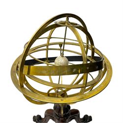 19th century brass terrestrial armillary sphere on rosewood base, lobe carved column on three splayed supports with scrolled carved terminals, the supports united by circular compass with turned stretchers