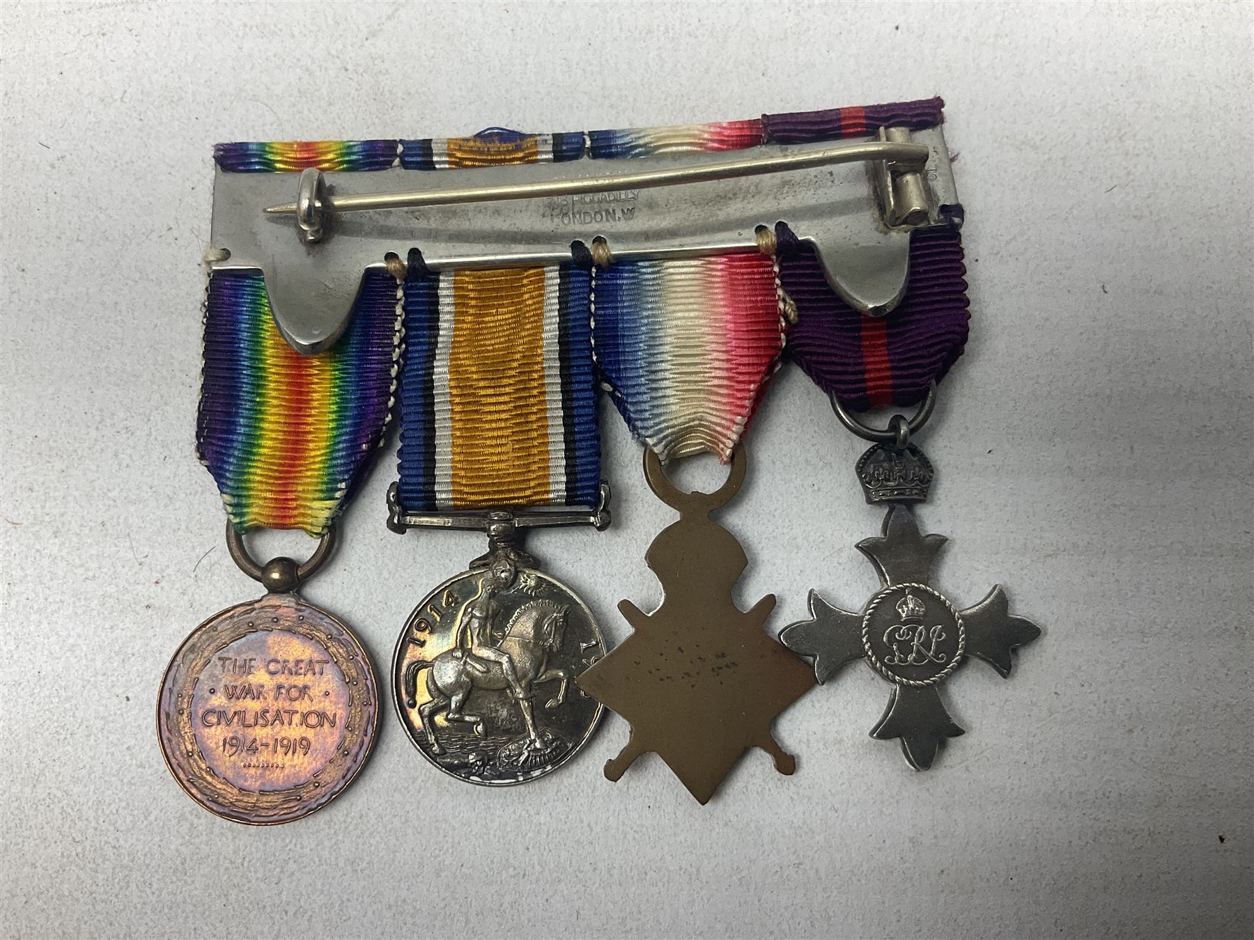 George V Military Cross miniature group of six medals comprising MC, WW1 trio including 1914 Star, Long Service and Good Conduct Medal and General Service Medal with Iraq clasp; and miniature group of four medals comprising Military OBE and WW1 trio including 1914-15 star; all with ribbons and both on pinned wearing bars