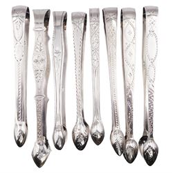 Collection of eight George III silver bright cut engraved sugar tongs, to include example with shaped arms, hallmarked Peter & William Bateman, London 1806, another hallmarked Samuel Godbehere, Edward Wigan & James Boult, London 1810, approximate total weight 7.51 ozt (233.6 grams)