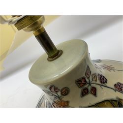 Moorcroft table lamp of squat baluster form, decorated in the Autumn Blackberry, with Moorcroft cream fabric shade with gold, green and red piping, overall H38cm