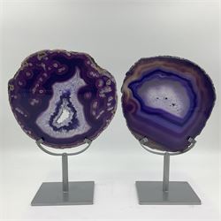Pair of purple agate slices, polished with rough edges, raised upon silvered metal stands, H26cm