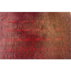 Afghan crimson ground Bokhara rug, the field with three rows of repeating Gul motifs, within six concentric guard bands decorated with repeating geometric patterns