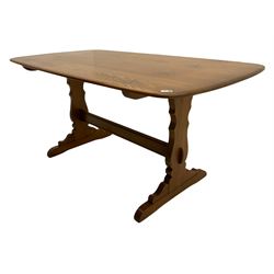 Ercol medium elm rectangular dining table, shaped end supports joined by stretcher, on sledge feet