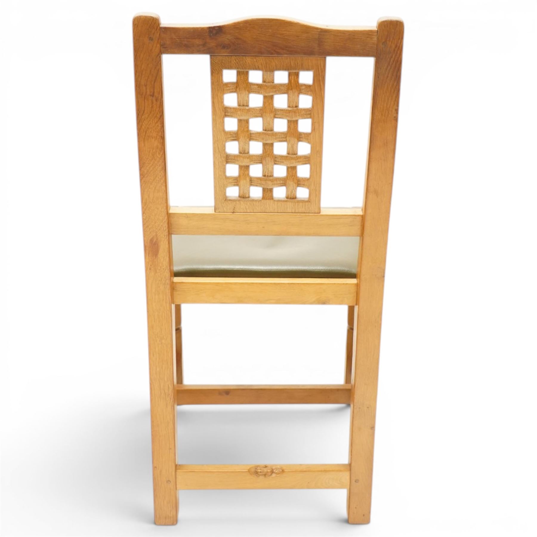 Beaverman - 1980s set of four lattice back dining chairs, shaped top rail above a lattice back, green leather fixed seat, raised on octagonal front supports, with carved Beaver to the back stretcher, by Colin Almack of Sutton near Thirsk