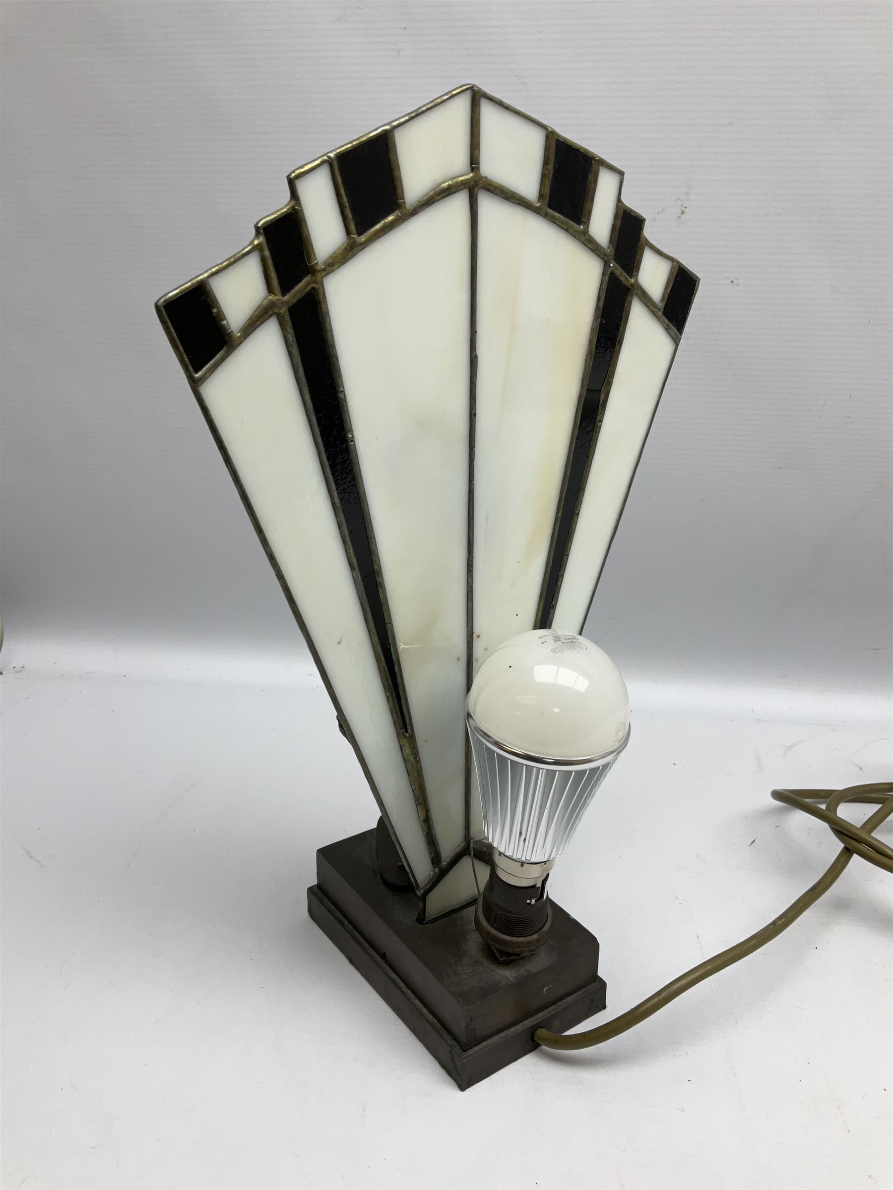 Art Deco style table lamp, modelled in the form of a bronzed female figure before a leaded glass fan shaped shade, H38cm