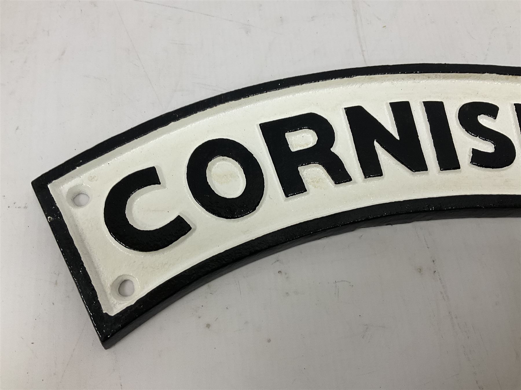 Arched cast iron Cornishman sign, L48cm