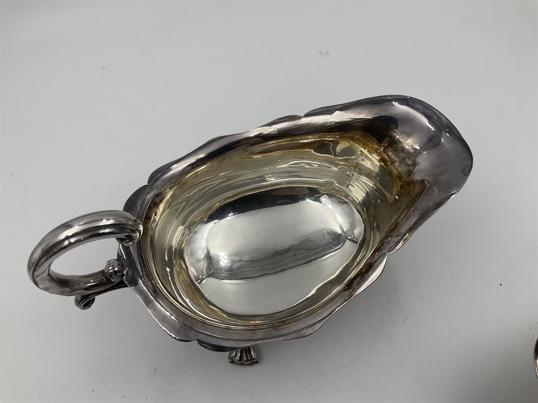 Silver plated seven bar toast rack by Mappin & Webb, together with other silver plated items including pair of bottle coasters, swing handled baskets and two sauce boats