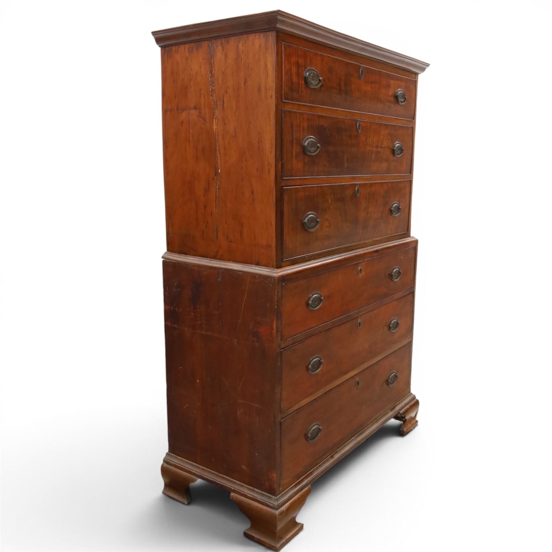 George III mahogany chest on chest, moulded cornice over two short over two long drawers with figured mahogany veneers, lower section fitted with three further long drawers, oval brass plate handles and escutcheons, on shaped bracket feet