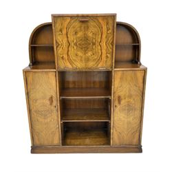 Early to mid 20th century Art Deco style walnut arch top writing cabinet, fall front enclosing fitted interior, two cupboards and shelving, on plinth base