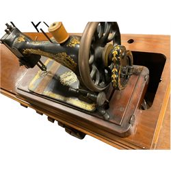 Late 19th century Singer walnut cased treadle sewing machine, with various accessories and original bill of sale dated. 1898 