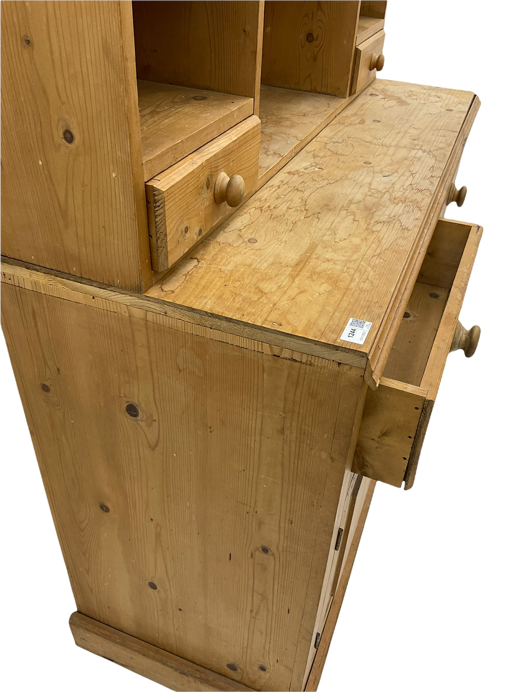 Solid pine dresser, raised plate rack fitted with small drawers over two drawers and double cupboard, plinth base