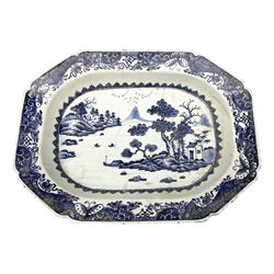 Late 18th/early 19th century Chinese export blue and white dish of canted form, decorated with a waterside landscape set with pagodas and boats between islands within a spearhead and Fitzhugh border, W38cm H28cm