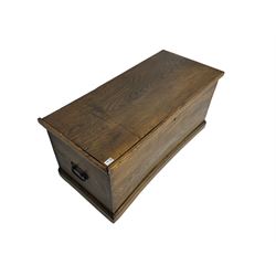 Elm blanket box, hinged lid enclosing candle box, fitted with metal carrying handles, on moulded plinth base