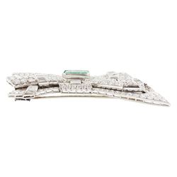 Platinum emerald and diamond bow brooch, central octagonal cut emerald of approx 4.00 carat, with round brilliant and baguette cut diamond surround, total diamond weight approx 23.00 carat