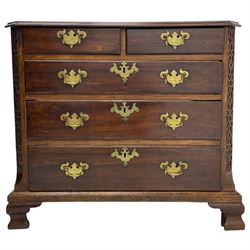George III Chippendale design mahogany chest, moulded rectangular top with canted corners, wide canted uprights with blind fretwork decoration, two short and three long with moulded fronts, shaped brass handle plates, on ogee bracket feet 