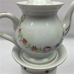 Two 19th century continental teapots and warmers, each teapot upon a cylindrical warming base, hand printed with floral sprigs , largest H26cm