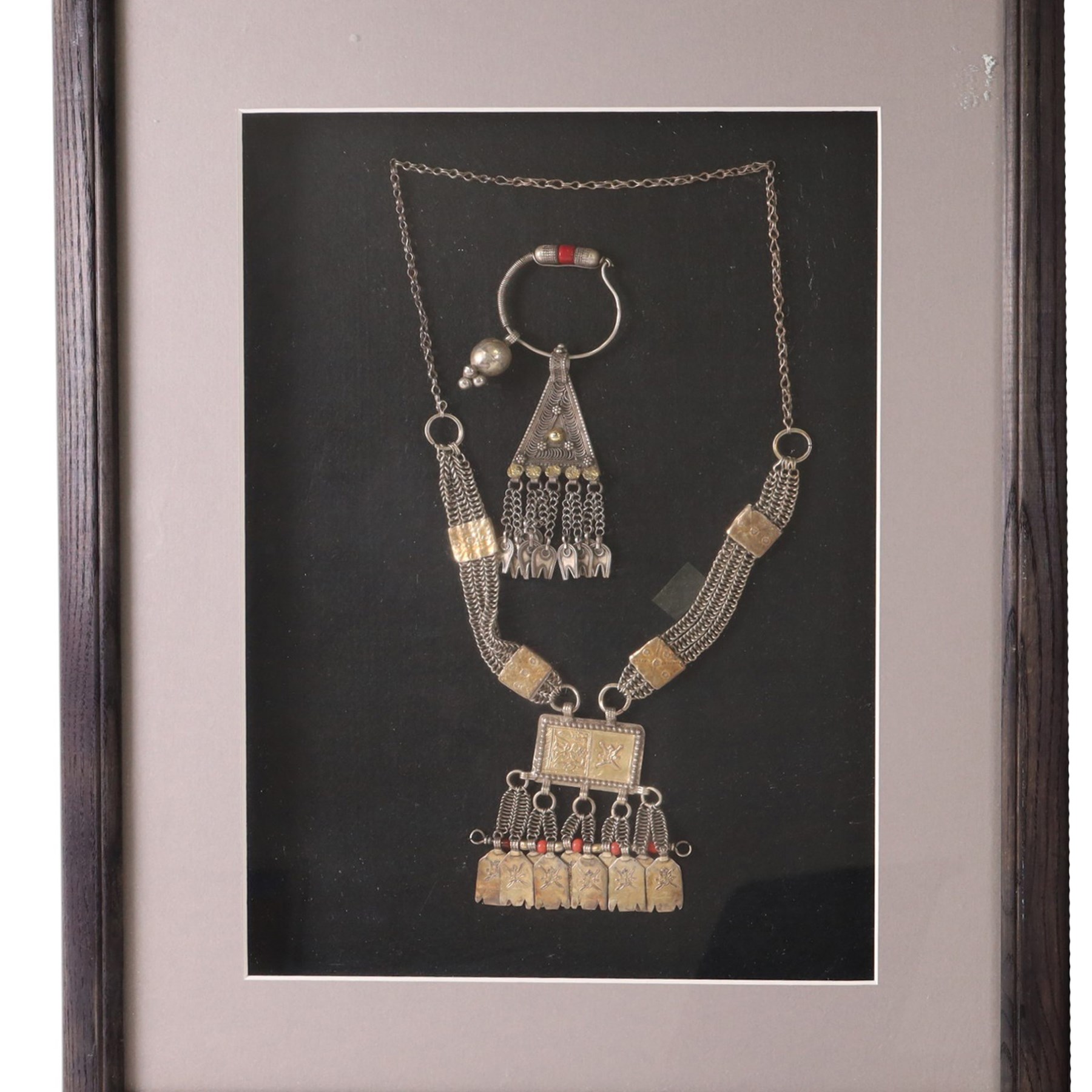 Framed Omani silver Hirz necklace, together with matching pendent, with filigree detail, together with another framed silver necklace 