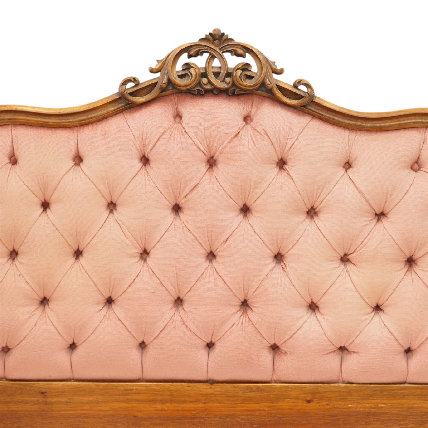 Two 20th century headboards, one with scrolled rail above a pink button backed board (H c127m, W 137cm) the second with flamed mahogany veneer (H 117cm, W 163cm)