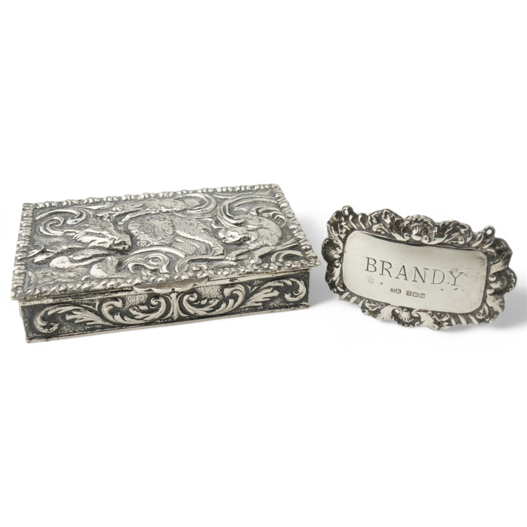 Spanish rectangular silver box, the hinged cover embossed with a hunting scene 9.5cm x 6cm 915 fineness mark and a silver decanter label 'Brandy'