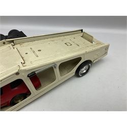 American Nylint large scale tin-plate car transporter L59cm carrying a Testor Toys plastic car; Tonka tin-plate mobile crane; boxed Sarony Cigarettes tin-plate roulette game with rules; and Japanese style tin-plate box, the lid inset with a revolving poker dice game (4)