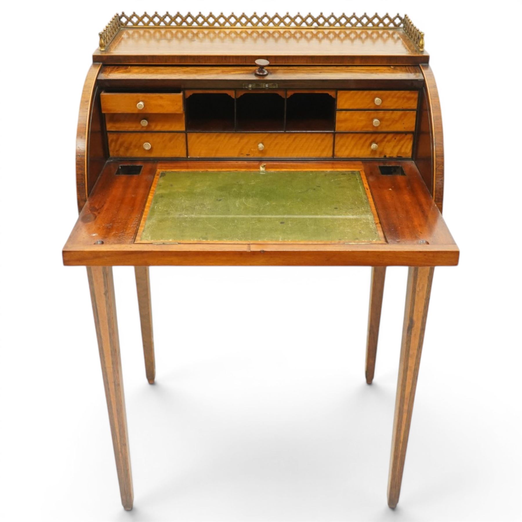 Regency period inlaid mahogany Ladies cylinder writing desk, the rectangular satinwood banded top with raised pierced brass three-quarter gallery, over a cylindrical roll-top enclosing a satinwood fitted interior with pigeonholes, correspondence drawers, ink wells and a sliding hinged writing slope, the base fitted with single frieze drawer, raised on square tapering supports
Provenance: Kirkham Hall