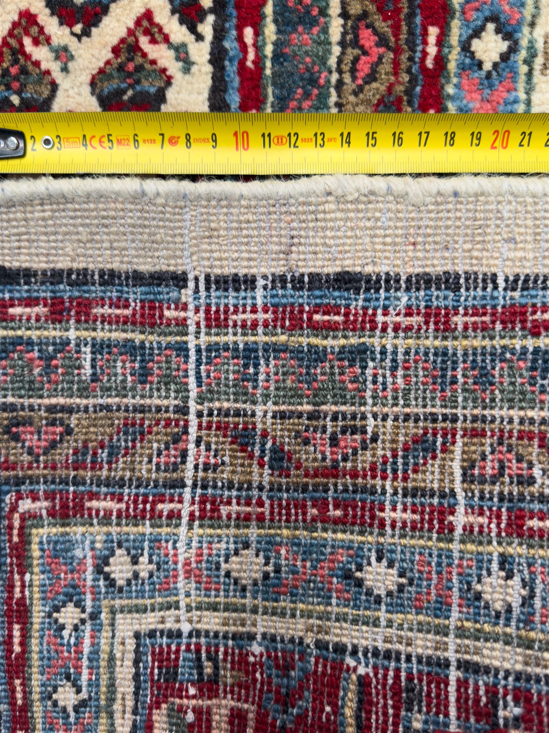 Northwestern Persian Bottehmir hand-knotted rug, ivory field with an all-over design of boteh motifs arranged in diagonal rows within multiple borders and a primary madder red field with stylized vine and flowerhead motifs, 320cm x 214cm 