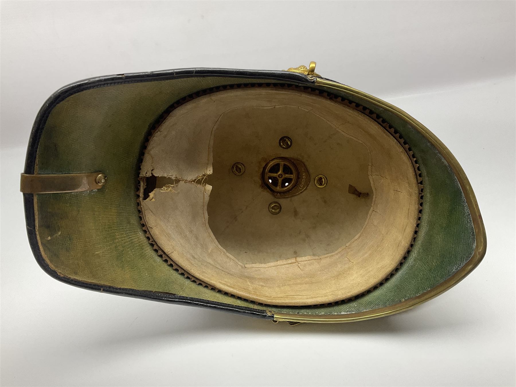 Post-1902 Welsh Regiment Officer's Home Service Blue Cloth Helmet with gilt metal King's crown helmet plate to the front, a removable spike to the top on a shaped cruciform base with rosette fittings, rosette side bosses, brass trim to the front peak, and leather and velvet backed chin scales, with sweat band, the interior with the remains of a makers label at the address 1,3 & 5 Lexington Street, Golden ? London W (presumably Hobson & Sons)