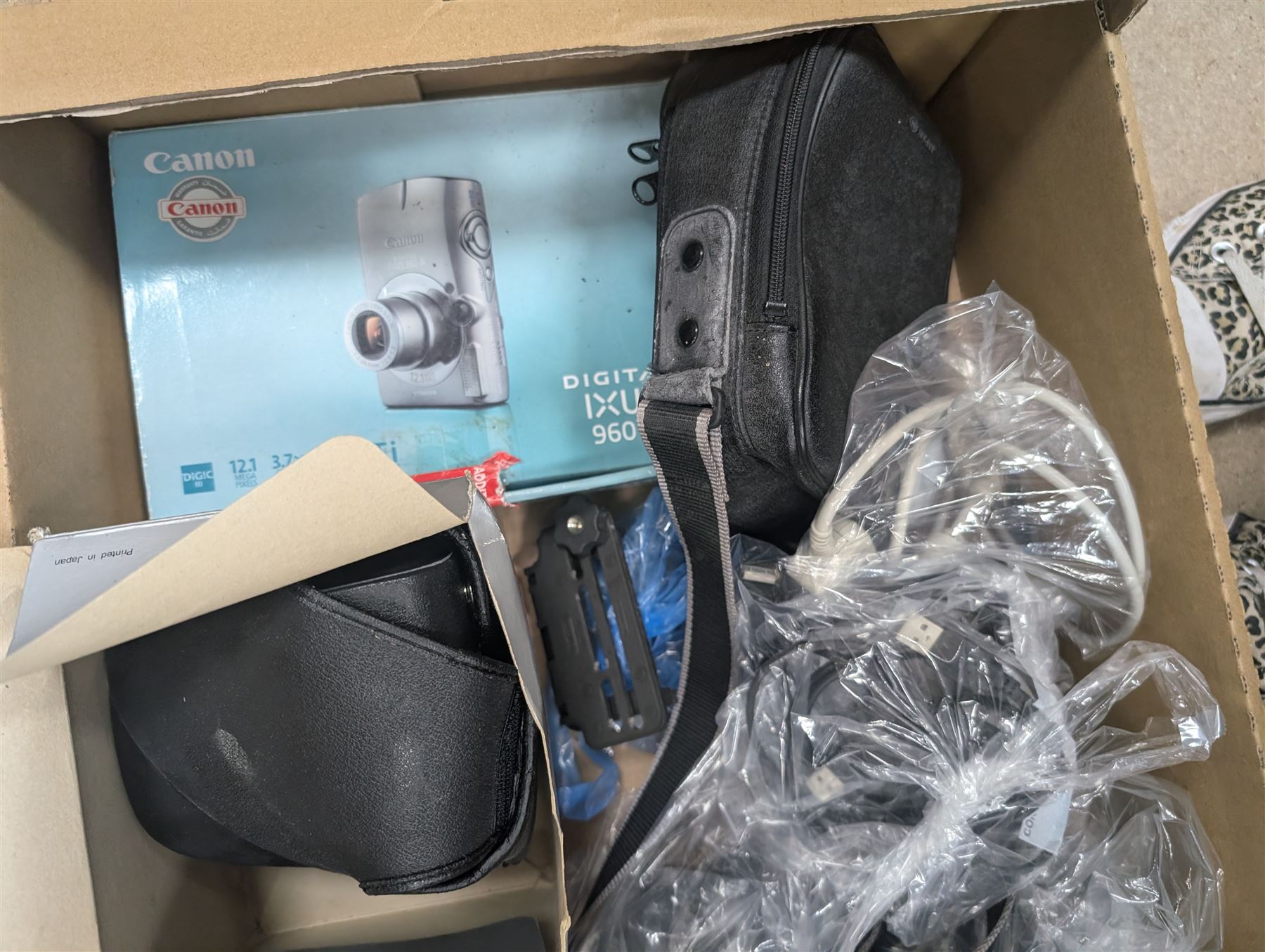 Collection of predominantly Canon camera accessories, including CanonScan FS40000US, cases, straps, cables, etc 