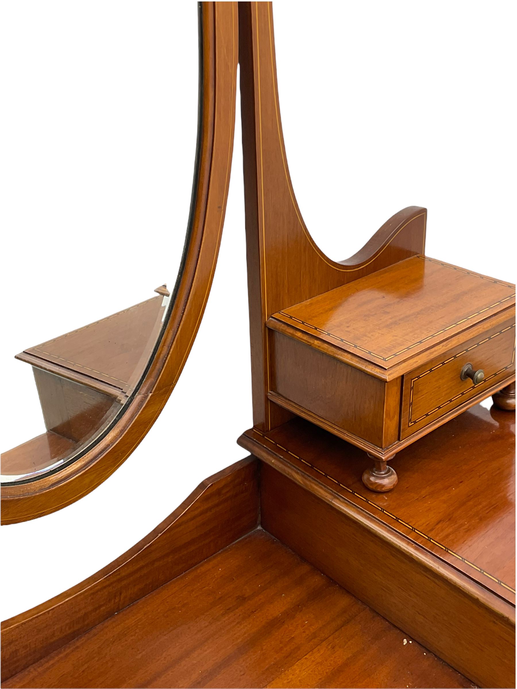 Edwardian inlaid mahogany dressing table, oval swing mirror, trinket drawers, above two small and two long drawers