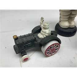 Collection of cast metal Michelin men, to include, one on a motor bike, come in a plane, one on a tractor and a large money box, money box H23cm