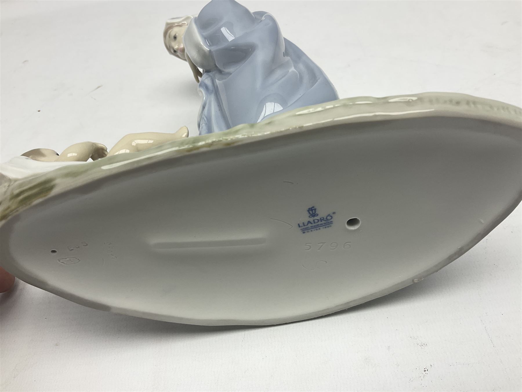 Lladro figure, Holy Night, modelled as Mary kneeling over baby Jesus, sculpted by Vincente Martinez, with original box, no 5796, year issued 1991, year retired 1994, H22cm