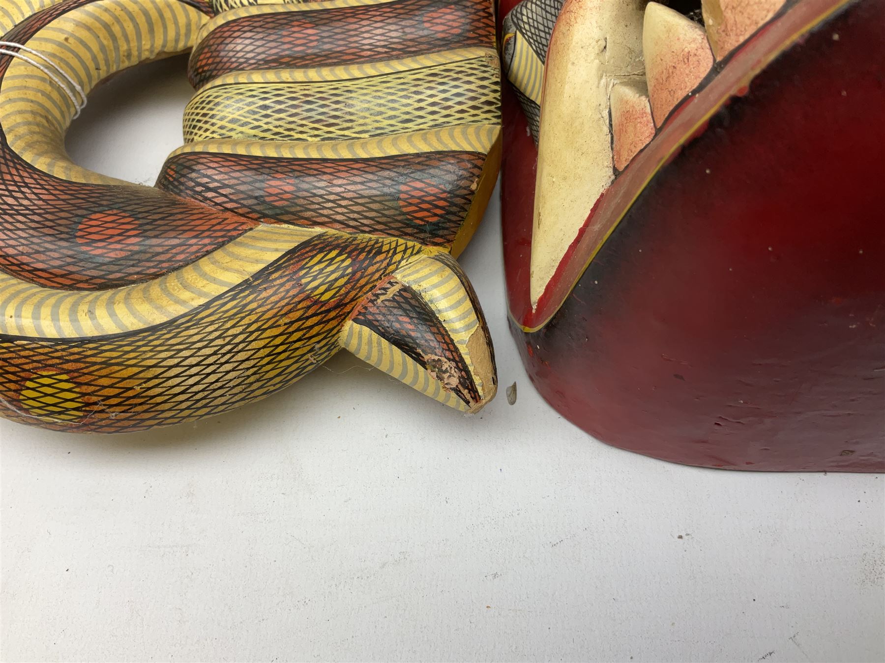 Sri Lankan Cobra mask depicting the demon Naga Raksha, together with a smaller example, largest H46cm