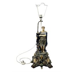 Composite table lamp modelled as a Roman Emperor donning blue robes, upon quatrefoil base modelled with rams heads and winged cherubs, H56cm excl fitting