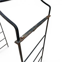 Antique wrought iron strapwork garden arch, with scroll form arched top with spearhead finials, over integral side trellis panels, in distressed black-painted finish