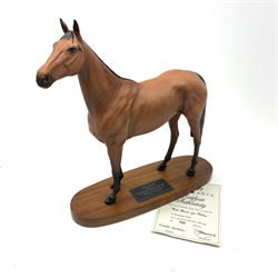 A Bewick figurine, modelled as a chestnut horse, Red Rum, raised upon an oval wooden base with plaque detailed ‘Red Rum Winner of The Aintree Grand National 1973, 1974 and 1977, The Scottish Grand National 1974’, including base H31.5cm. 
