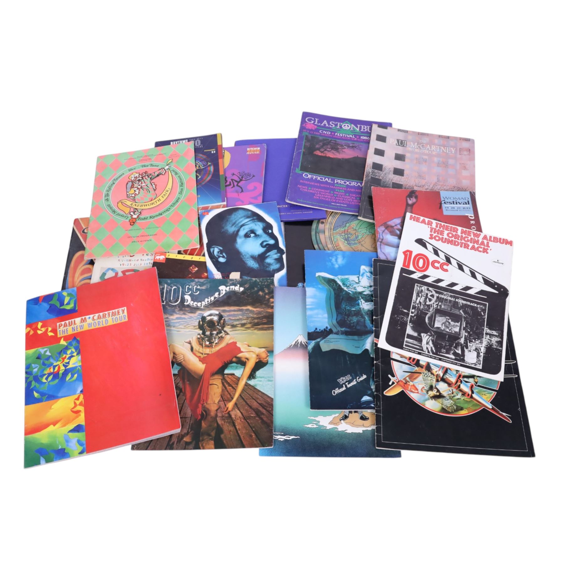 Music memorabilia, including cardboard globe, a free gift with the Wings Over America vinyl, music programmes, including Concert for George, Paul McCartney World Tour, Wings programmes, Glastonbury 1986, 10CC programmes, Knebworth Fair 1976 programme, etc