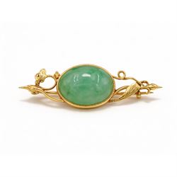 21ct gold jadeite brooch, oval cabochon cut jadeite in a floral setting