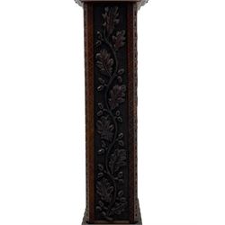 Late 19th century carved oak pedestal torchère stand, stepped and moulded square top carved with foliage, each side carved with trailing foliage with putto or mask, on stepped and moulded base carved with foliate lunettes 