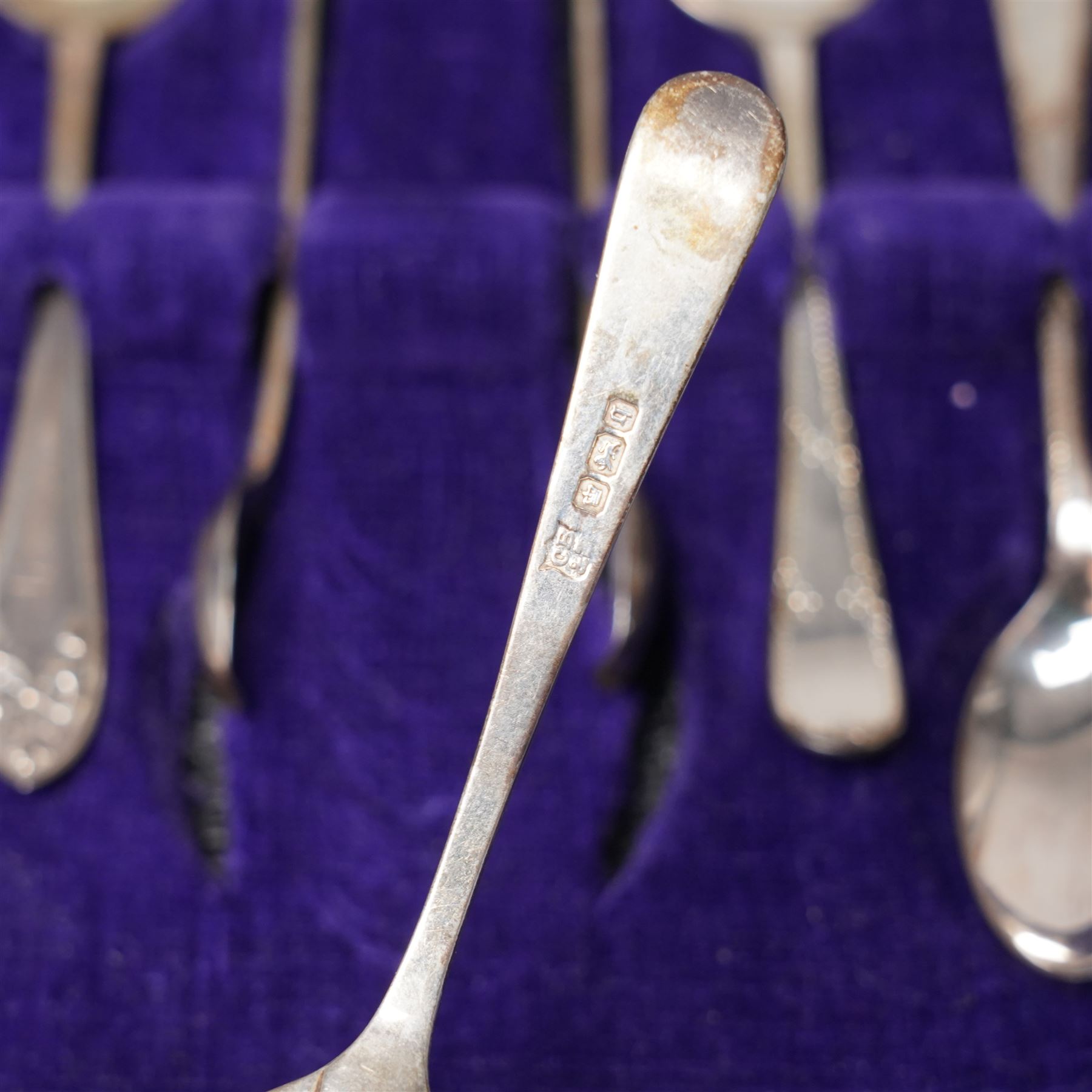 Set of  of six silver coffee spoons and tongs with bright cut decoration Sheffield 1908 Maker Cooper Bros. and another set of six coffee spoons with decorative terminals