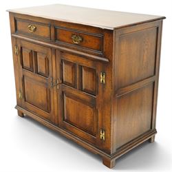 18th century style oak dresser base, rectangular moulded top over two frieze drawers with brass handles, twin panelled cupboard doors below with pierced brass escutcheons, on stile feet