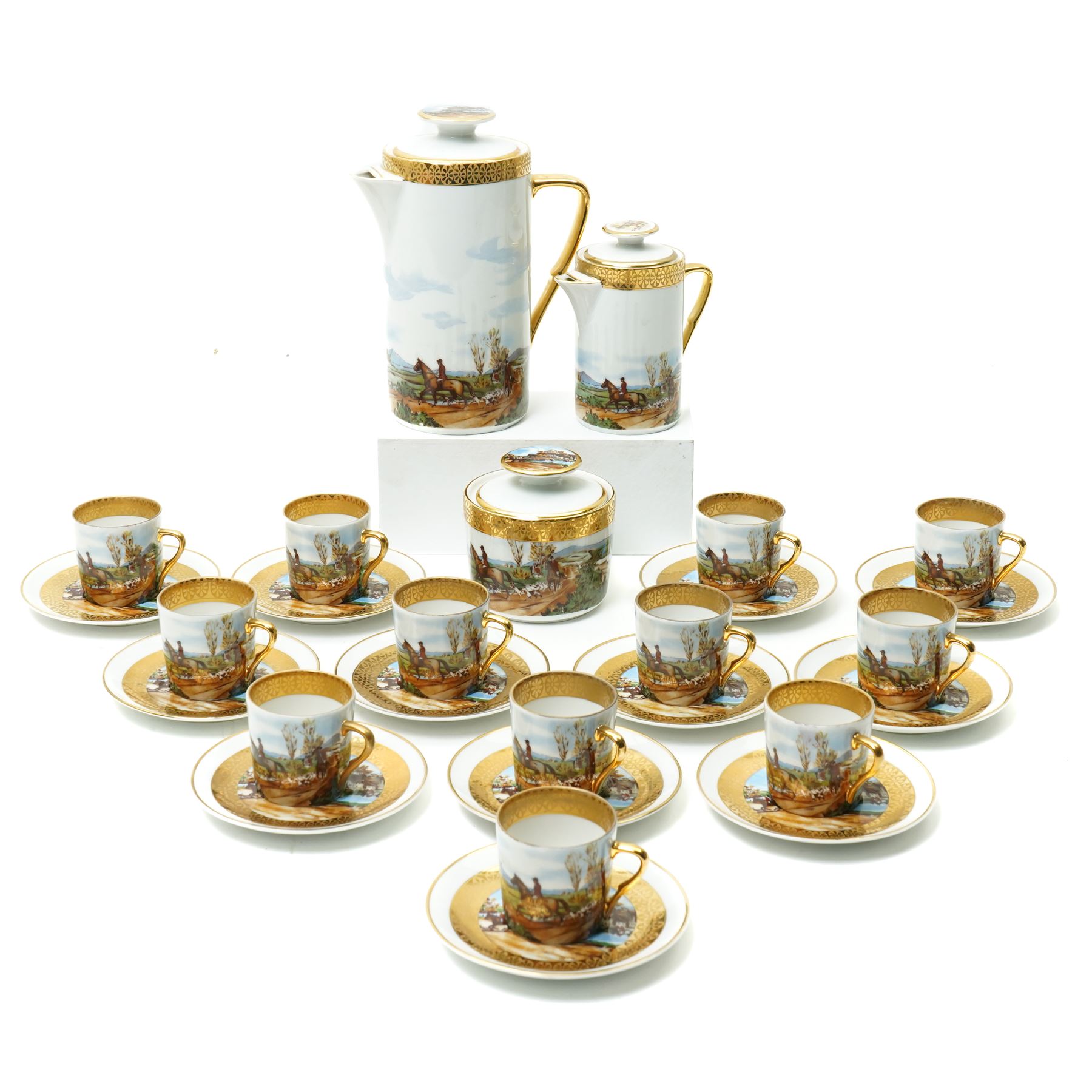 Limoges  coffee set decorated with hunting scenes within a gilt border comprising twelve cups and saucers, coffee pot, cream jug and sugar bowl
