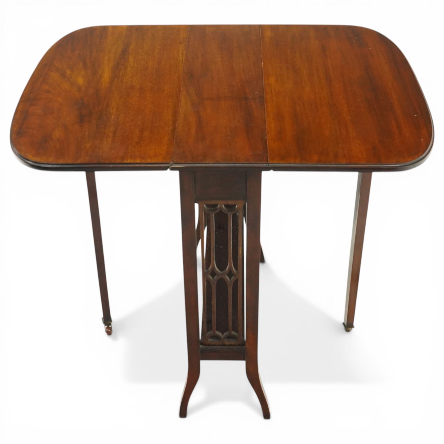 Edwardian mahogany Sutherland table, rectangular drop-leaf top with rounded corners, raised on gate-leg base with pierced end supports