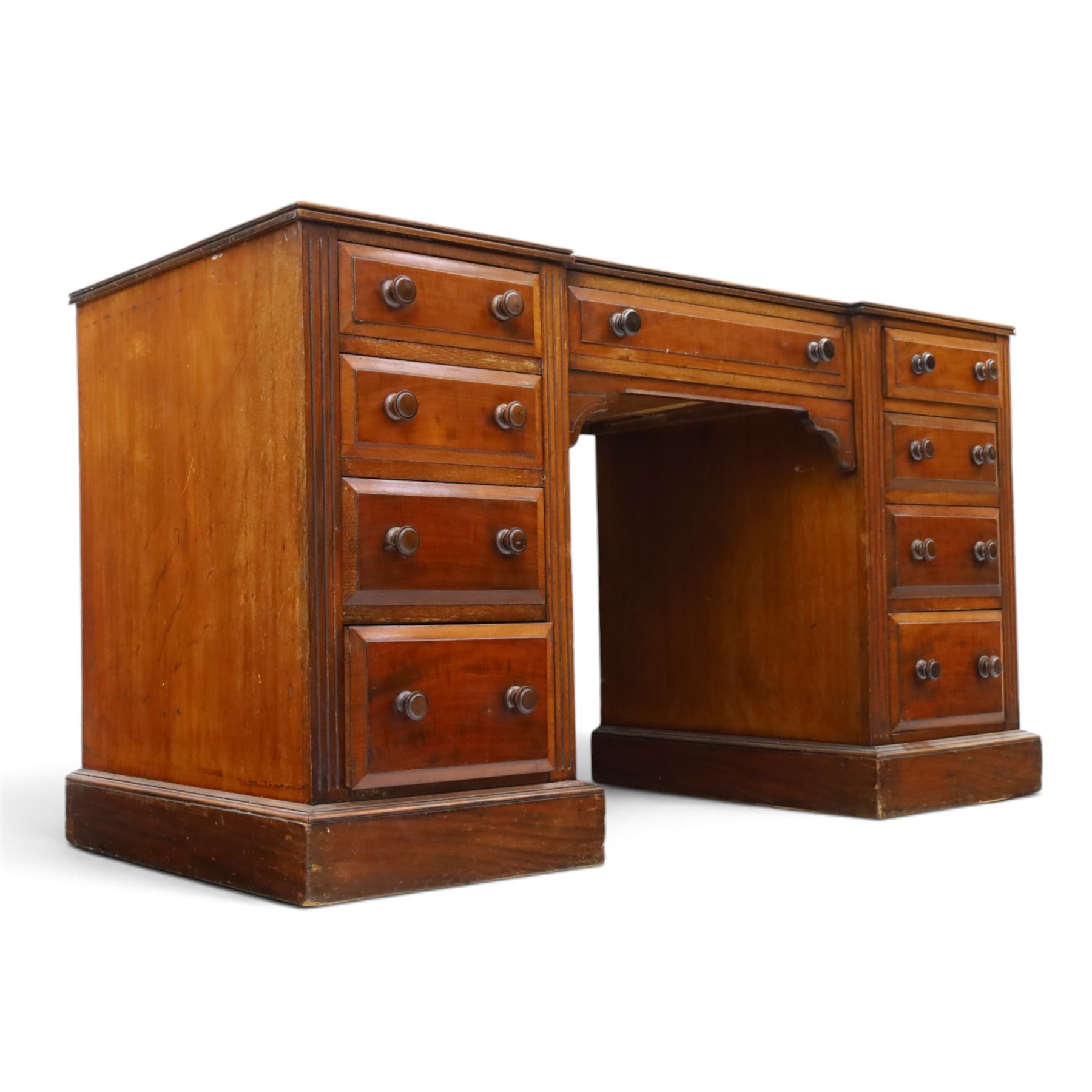 Victorian mahogany inverse breakfront twin pedestal desk, inset leather top over central drawer, flanked by pedestals with four graduating drawers, raised on a plinth base