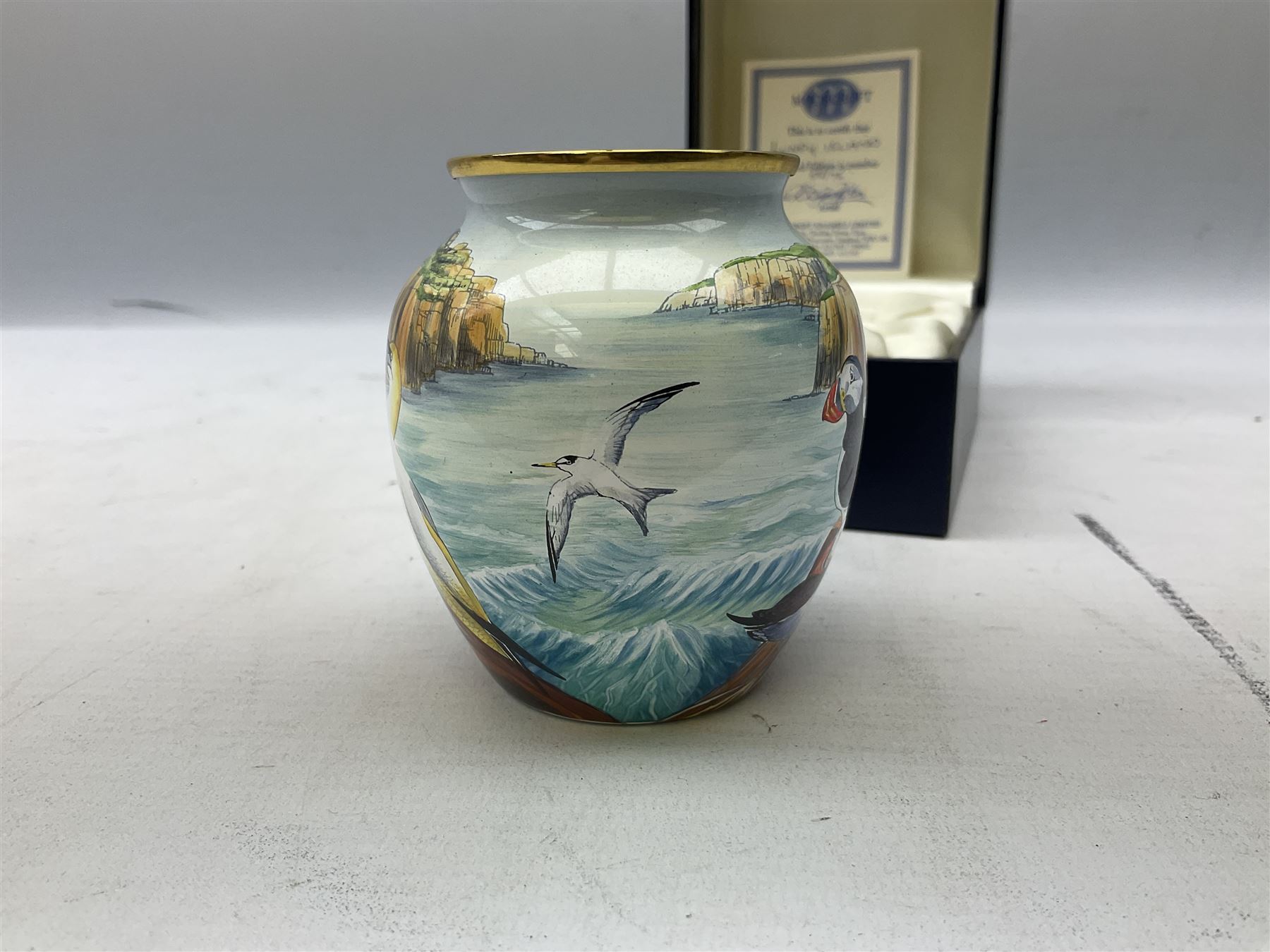 Limited edition Moorcroft enamel vase, decorated in the Lundy Island pattern, with certificate signed by the artists, no 58/75, in fitted box
