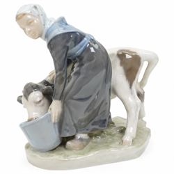 Three Royal Copenhagen figures, including Boy leading two Calves no. 1858, Boy with Calf no. 772, and Girl feeding Calf no. 779