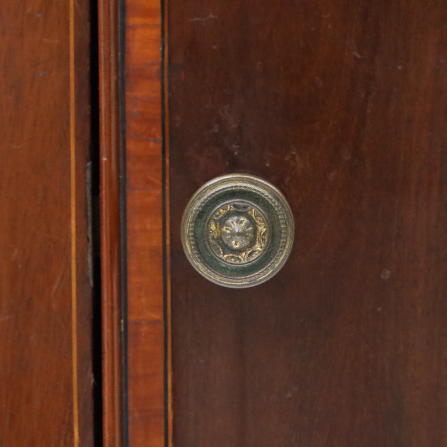 Edwardian mahogany pot cupboard, with three quarter galleried top, single cupboard door, raised on square tapering supports terminating in spade feet